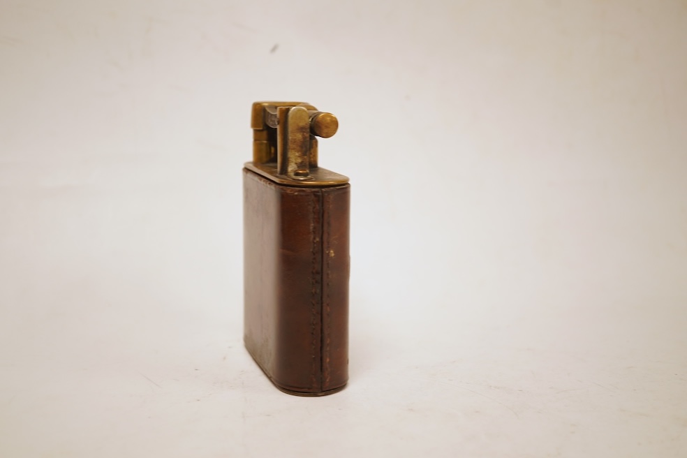 A Dunhill giant table lighter with brown leather outer cover, 11cm